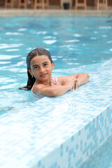 A beautiful young girl in the swimming pool. Adorable little girl is enjoying her time on a sunny...