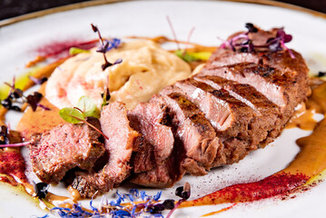 Roasted Duck breast fillets with vegetable pure in plate