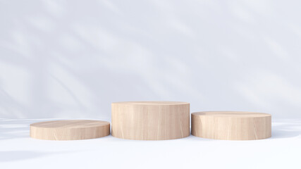 Three cylindrical wooden product display podiums with shadow nature leaves on white background. 3D render