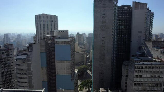 Aerial view rising over streets, past the Edif&iacute;cio Copan, in Republica, Sao Paulo, Brazil