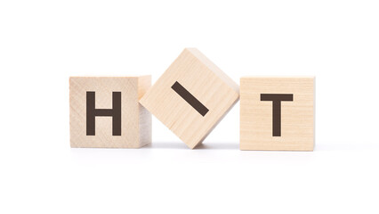HIT - wooden blocks with letters, top view on white background