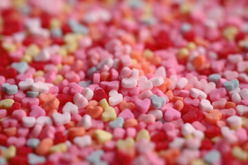 Close up shot of tiny heart shaped sugar candy sprinkles