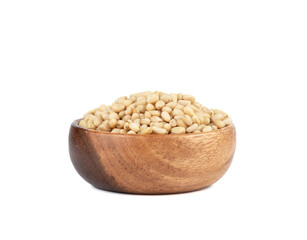Peeled pine nuts in a wooden bowl on a white background.