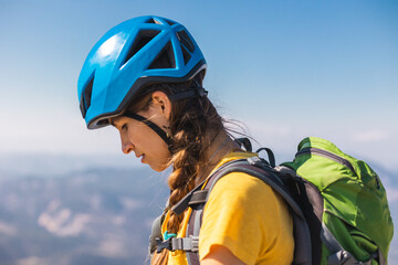 Portrait of a woman in a helmet for mountaineering and climbing. Safety in extreme sports. outdoor sports, fit and active women.