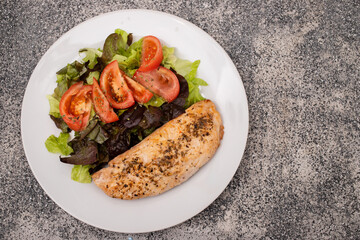 Baked turkey with vegetable fresh salad on plate