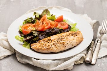 Baked turkey with vegetable fresh salad on plate