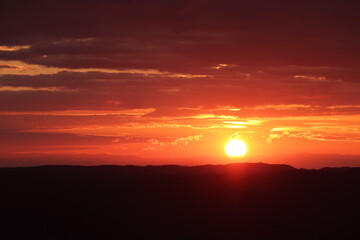 Fototapeta premium red sun comes down landscape