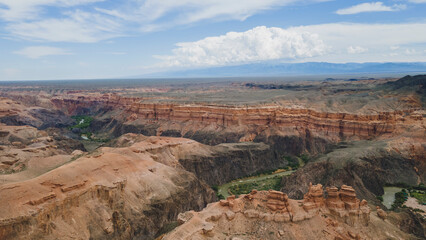 A view of a large canyon with a winding river in the gorge
