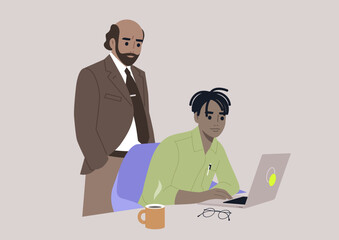 A senior manager supervising an intern in the office