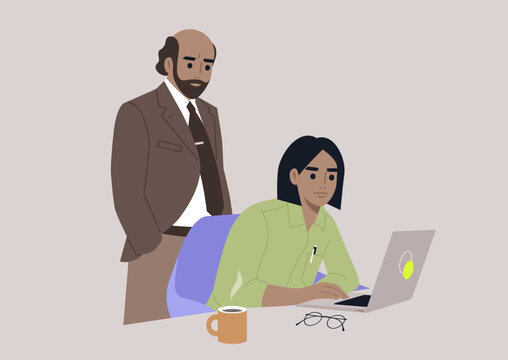 A senior manager supervising an intern in the office