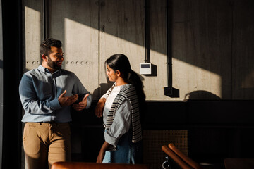Indian people talking while standing indoors