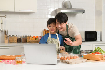 Happy smiling Young Asian father and son making video call to mother. enjoy cooking in kitchen at home