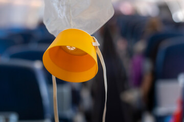 oxygen mask drop from the ceiling compartment on airplane..