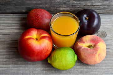Fresh ripe fruits and a glass of juice.Multi fruit juice.Juice mix fruit on wooden table.Healthy drink or diet concept.Selective focus.
