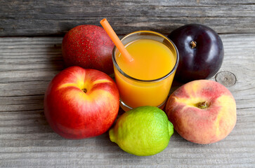 Fresh ripe fruits and a glass of juice.Multi fruit juice.Juice mix fruit on wooden table.Healthy drink or diet concept.Selective focus.