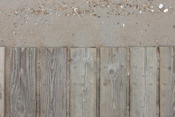 wooden boards on beach sand