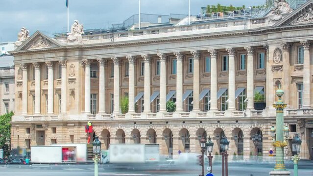Architecture of Place de la Concorde timelapse in Paris. Repearing works on a facade. Traffic on a road. Cloudy sky at summer day. Paris, France.