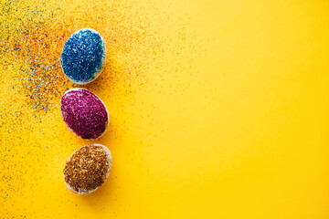 Happy easter! Creative preparing for Easter by decorating eggs with colorful glitter. Happy easter concept