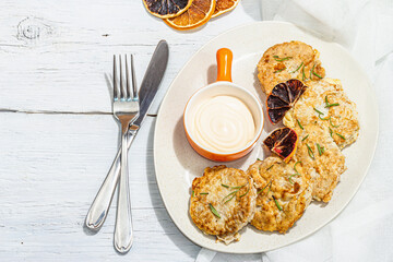 Hake fillet fried in batter. Sauce, fresh rosemary, dry lemon slices. Vegetarian food concept