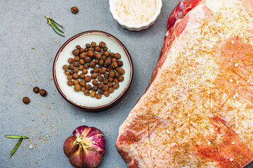 Raw pork shoulder with spices and herbs. Fresh meat cut, ingredient for cooking protein food