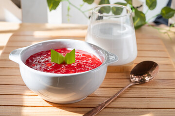 Pearl Porridge or pearl sago. Popular Indonesian desserts are commonly encountered during the month of Ramadhan. Served in a ceramic bowl with pandan leaves.