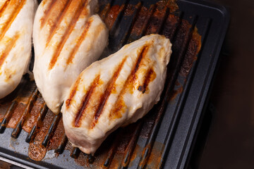 chicken breast cooked on an electric grill. Beautiful grilled chicken