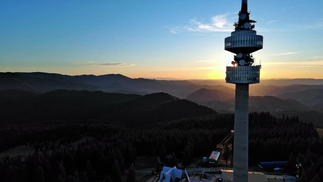 Tower Snezhana on peak of Snezhana covered with spruce forests in Rhodope mountains