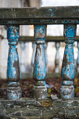 a balustrade on the railing of an old cracked staircase