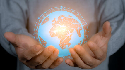 Close up of businesswoman hand holding glowing world technology connection concept. Global connection concept with digital planet in hands.