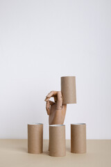 Empty toilet paper rolls with wooden hand. Paper tubes
