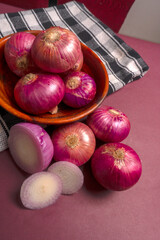 Fresh whole Red onions and one sliced of onion isolated on background.