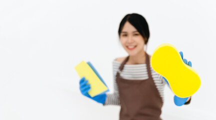 Happy asian woman in blue gloves smiling while posing with sponge . portrait looking at camera . isolated on white background.