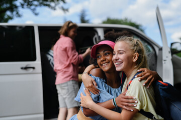 Multiracial young friends travelling together by car - summer vacation, holidays, travel and road...