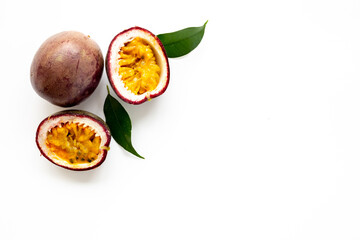 Closeup of whole and half of fresh passion fruit with leaf