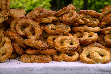 Freshly made homemade soft pretzels sprinkled with various seeds.