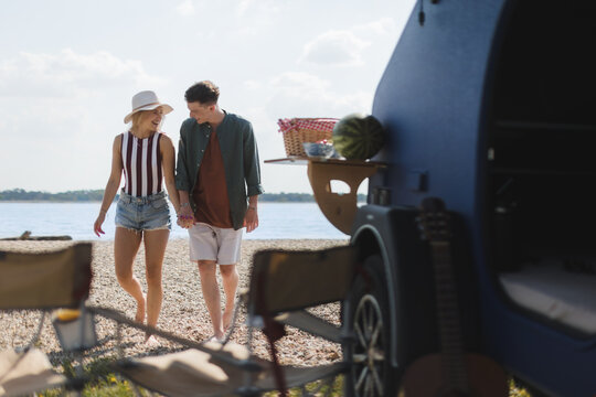 Young Couple In Front Of Van During Summer Vacation.