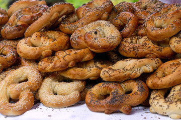 Freshly made homemade soft pretzels sprinkled with various seeds.