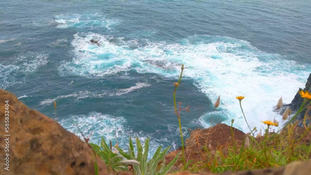 Wall mural Waves of turquoise water crash against the rocks