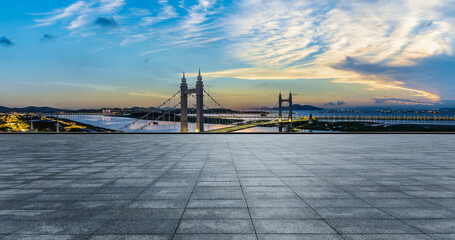 Empty square floor and bridge with sea natural scenery at sunset