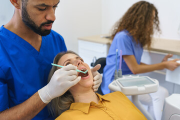 Fototapeta premium Dental examination of young woman at dental clinic.