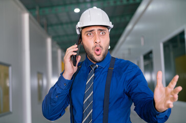 angry businessman manager in suit shouting with serious stress and aggressive bad problem in factory warehouse office with team by mobile phone