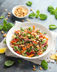Asian Quinoa salad with fresh vegetables, peanuts and herbs. Healthy food.