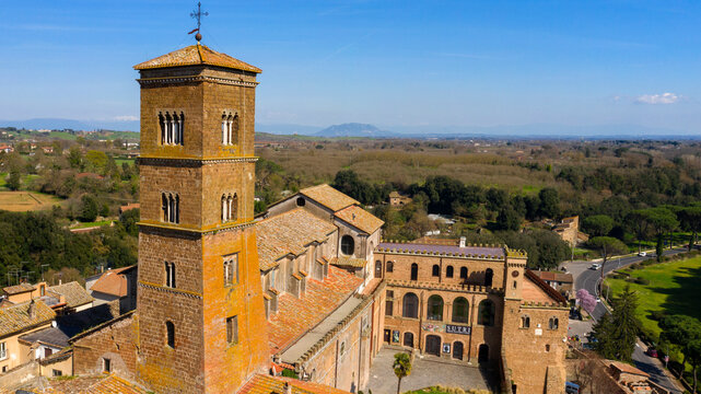 Aerial view of the cathedral Santa Maria Assunta in the historic center of Sutri, town located near Viterbo and Rome, Italy. The Romanesque church with its bell tower dominates the city.