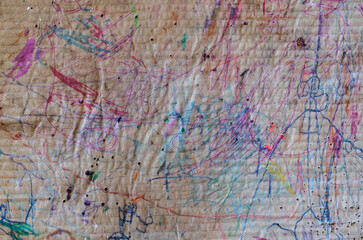 Fototapeta na wymiar art concept, horizontal corrugated beat up cardboard covered in marker and crayon scribbles, room for copy