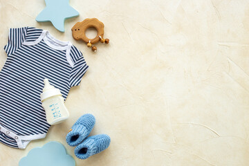 Baby cotton bodysuit with toys flat lay, top view