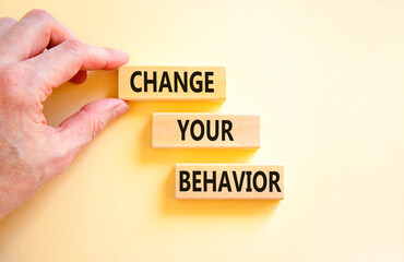 Motivation and Change your behavior symbol. Concept words Change your behavior on wooden block on a beautiful white table white background. Business change your behavior concept. Copy space.