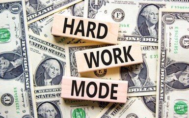 Hard work mode symbol. Concept words Hard work mode on wooden block on a beautiful background from dollar bills. Dollar bills. Business and Hard work mode concept. Copy space.