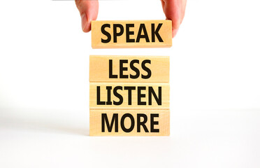 Speak less listen more symbol. Concept words Speak less listen more on wooden block. Beautiful white table white background. Motivational business speak less listen more concept. Copy space.