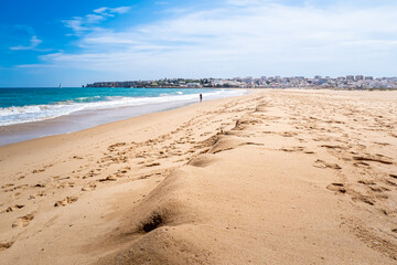 At low tide, Beach Meia Praia stretches far and wide with empty shoreline and calm waves, with an...