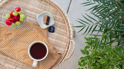 Tea cup and fruits on a wooden table